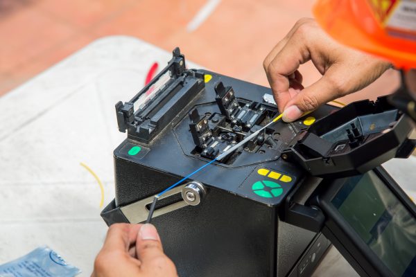 Technicians are cutting and fusion fiber optic cables.